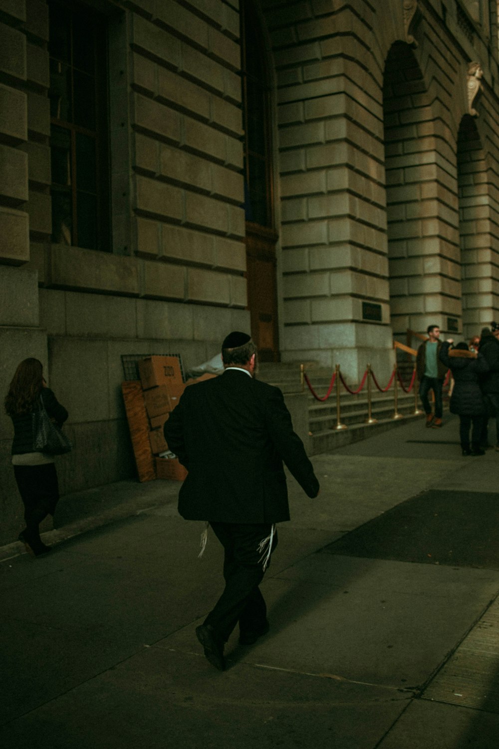 man walking on sidewalk