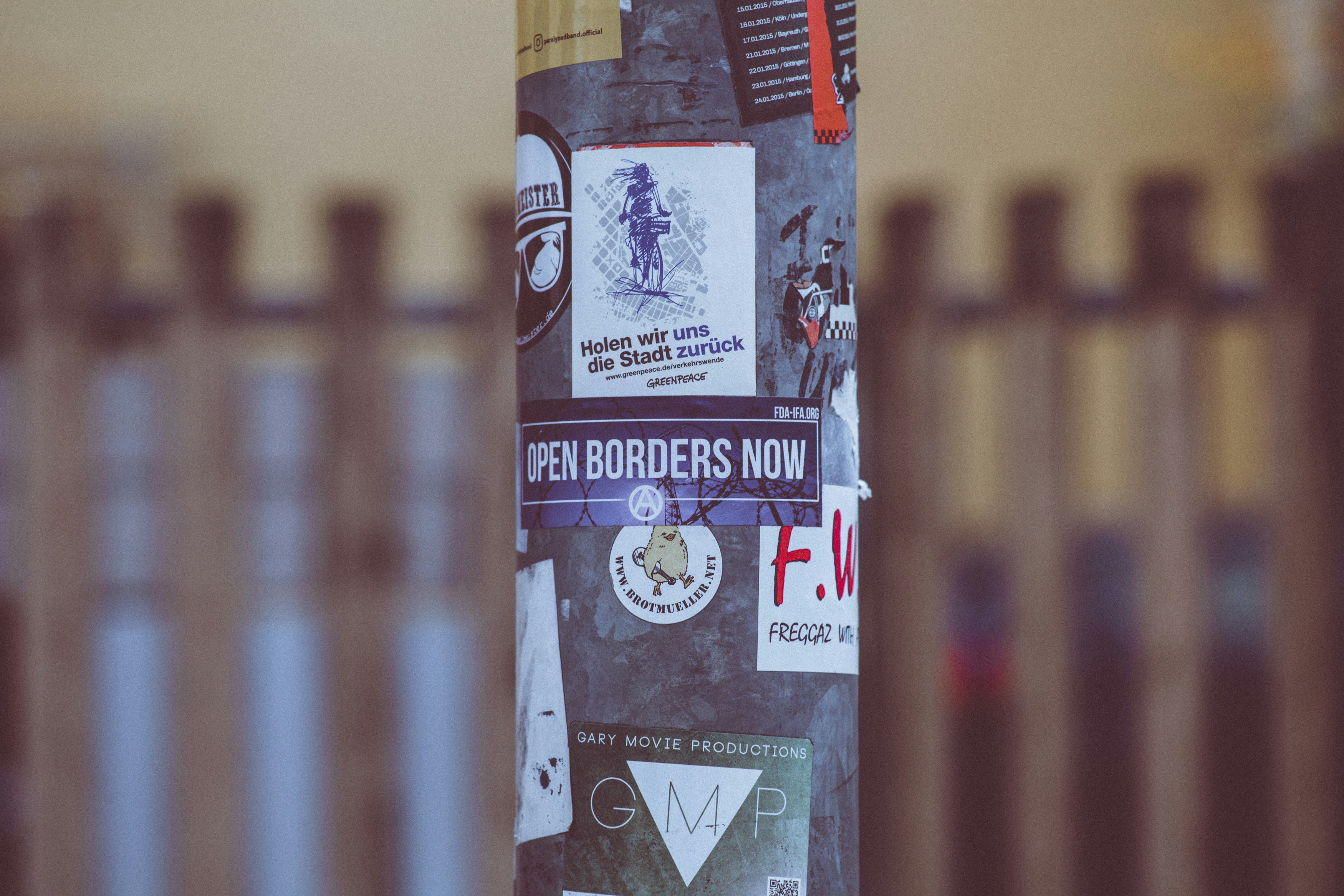 Urban street art sticker OPEN BORDERS NOW. Made with Canon 5d Mark III and analog vintage lens, Leica Elmarit-R 2.8 135mm (Year: 1987)
