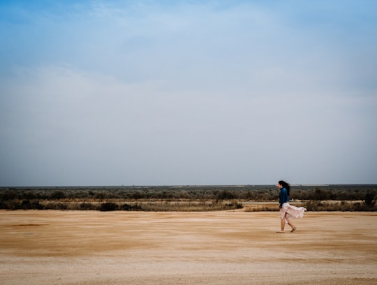 woman walking on brown field in Nullarbor SA Australia