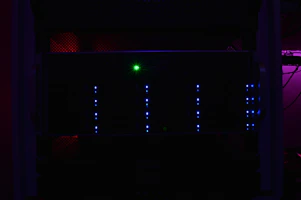 A modern server rack glowing with blue LED lights in a cool tech environment.