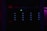 A dark server rack illuminated by faint blue LED lights, with a prominent green light in the center. The surrounding environment is dimly lit, creating a mysterious and technical atmosphere.