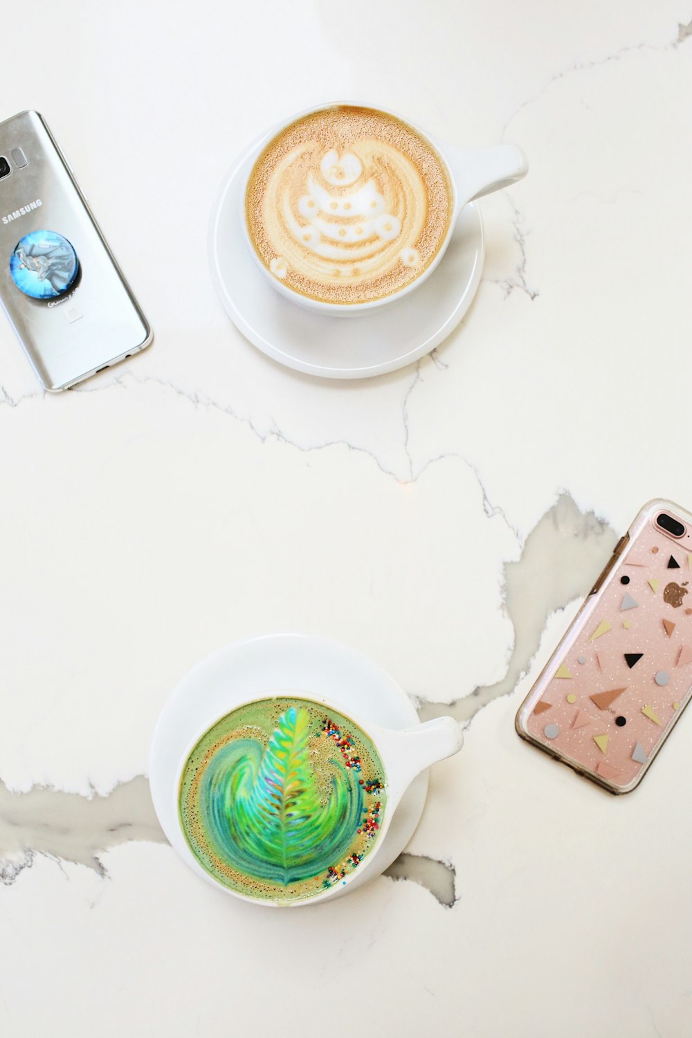 white ceramic cups filled with cappuccino