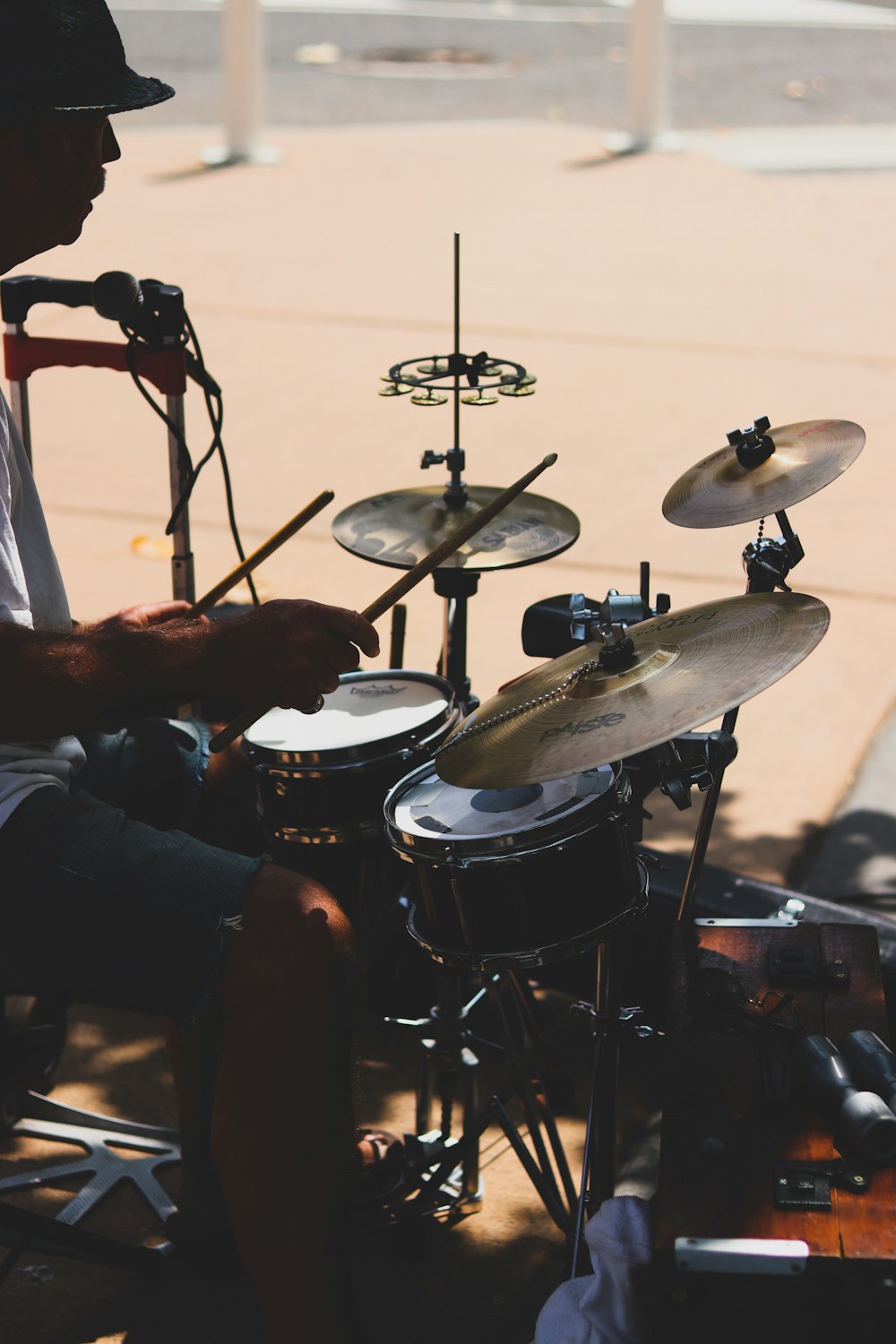 man playing drum set during daytime