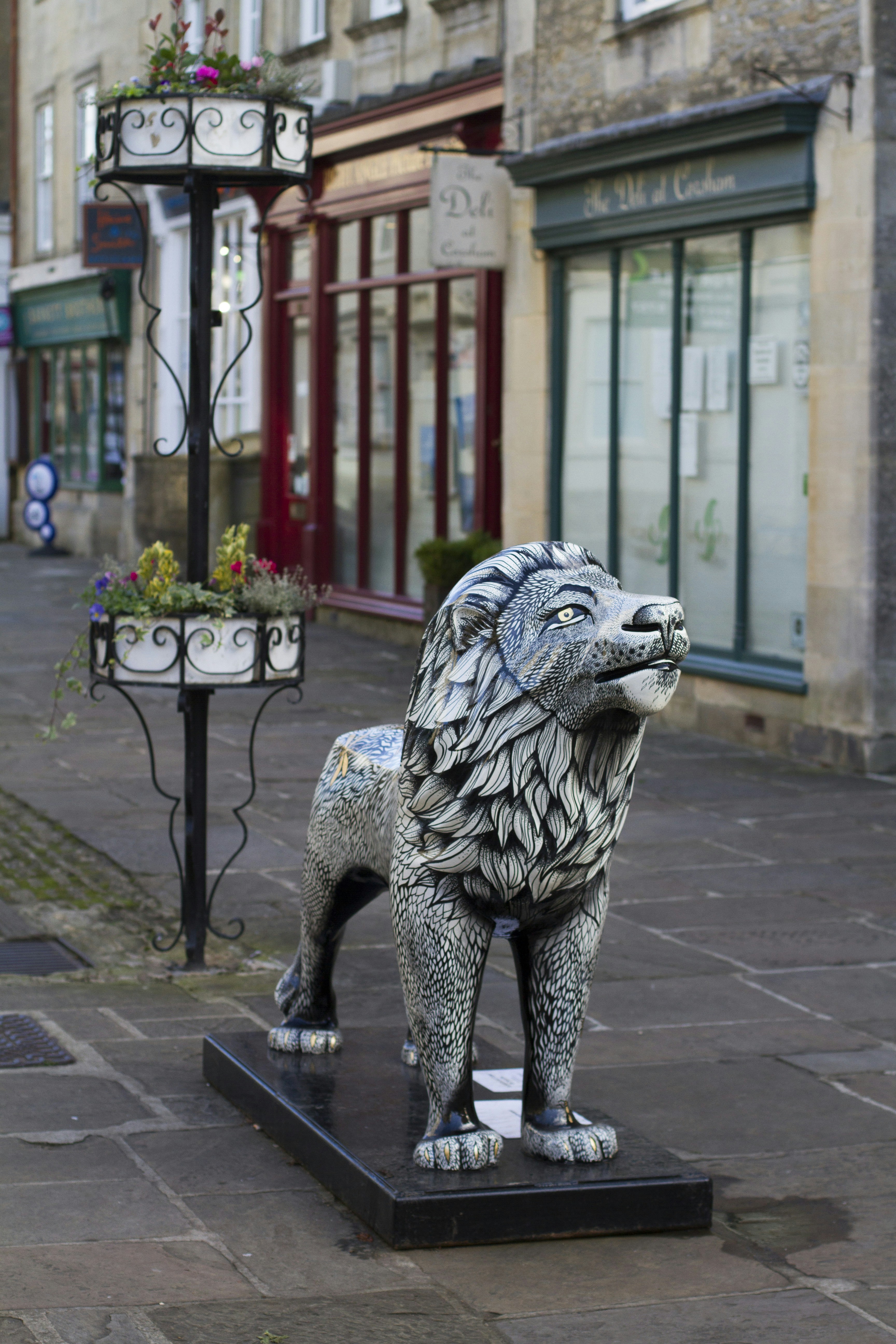 Lion statue near commercial building photo Free Banister Image on