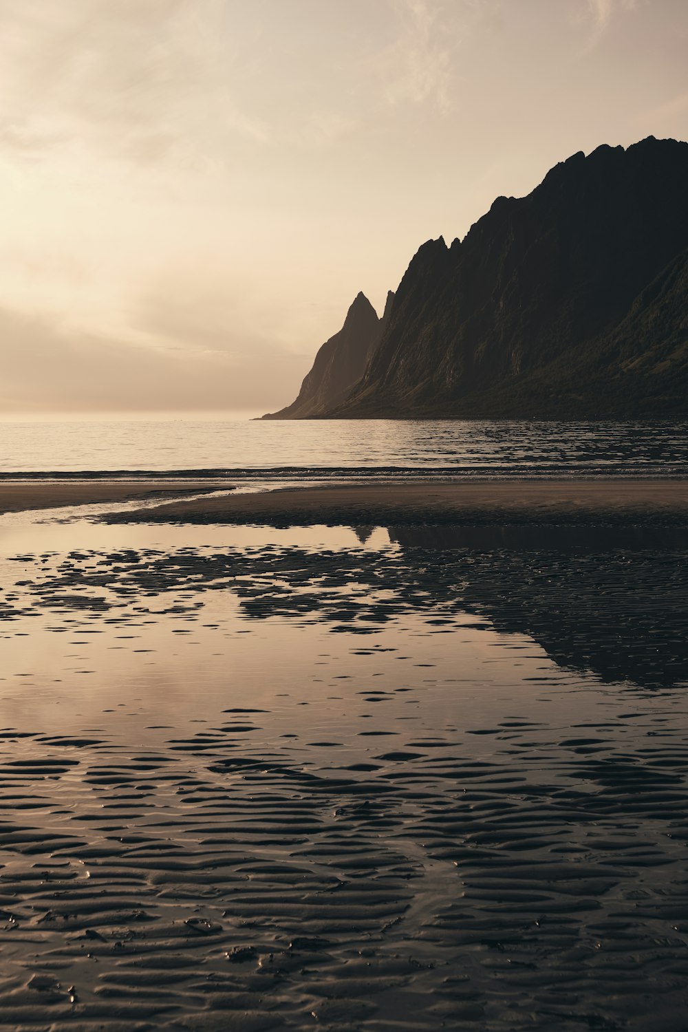 body of water beside mountain