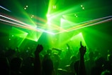 people dancing inside room with green lights