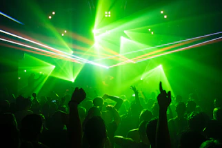 people dancing inside room with green lights