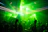 A vibrant crowd dancing under colorful laser lights at a pulsevibe rave event.