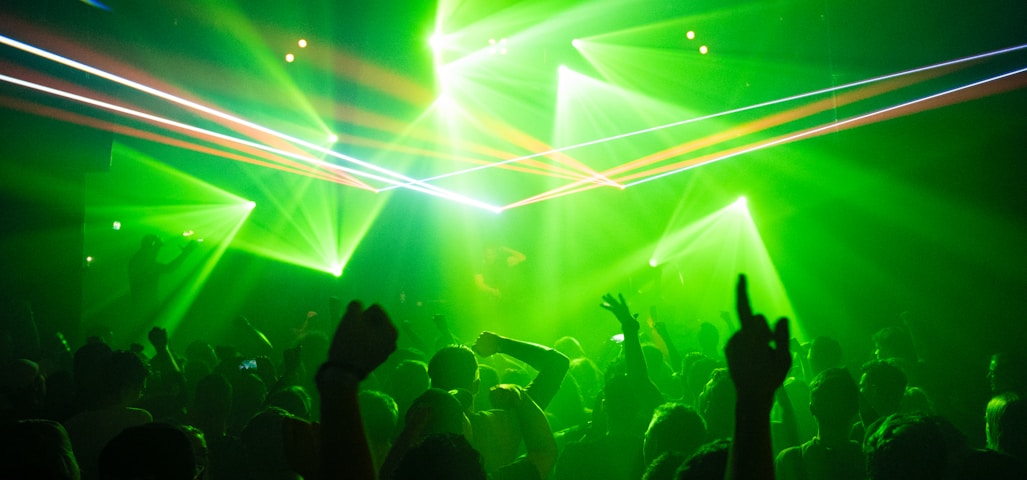 people dancing inside room with green lights