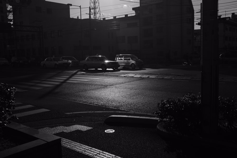 grayscale photo of cars travelling on road