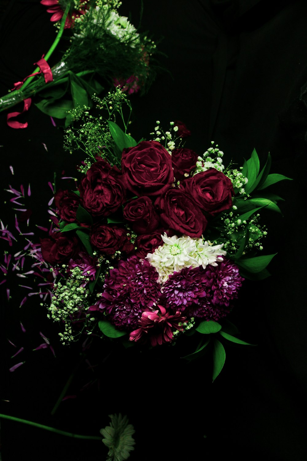 selective focus photography of red and white flower centerpiece