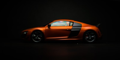 Multiple car images displayed in a clean grid with orange and black accents.