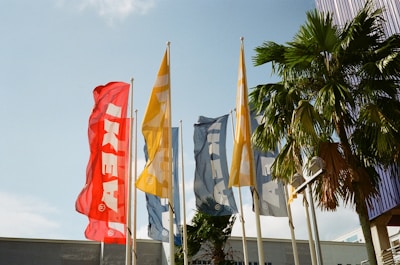 A vibrant display of various lion and sun flags waving gently outdoors.