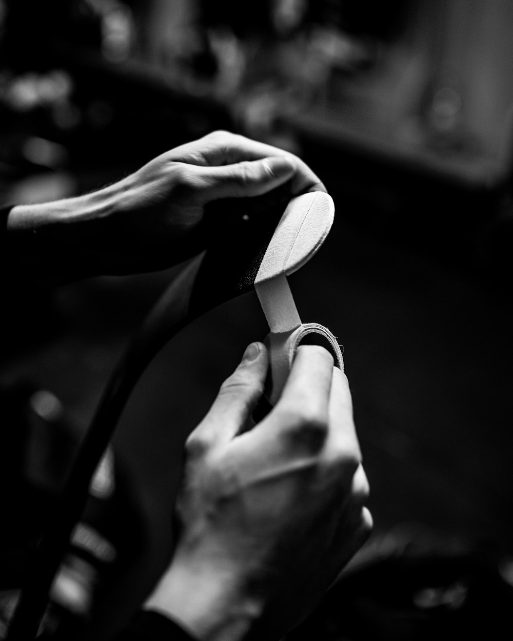 grayscale photo of person holding flip flop