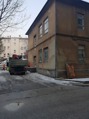 A professional inspecting a commercial building’s exterior during winter preparations