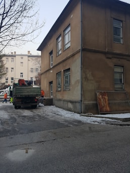 A professional inspecting a commercial building’s exterior during winter preparations
