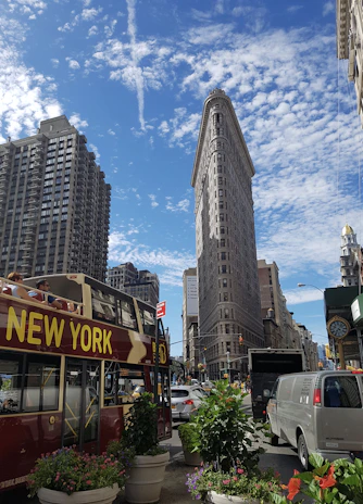 A group of tourists enjoying the vibrant streets of New York City with skyscrapers in the background.