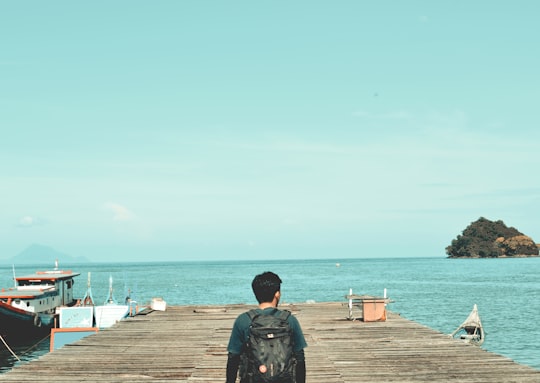 man carrying black backpack during daytime in Aceh Indonesia