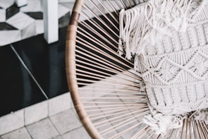 Modern indoor armchair made with synthetic fiber and intricate nautical knit design.