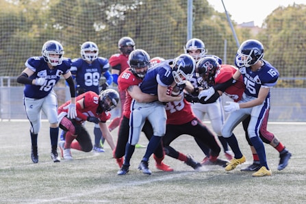 two teams playing football during daytime