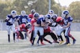 two teams playing football during daytime