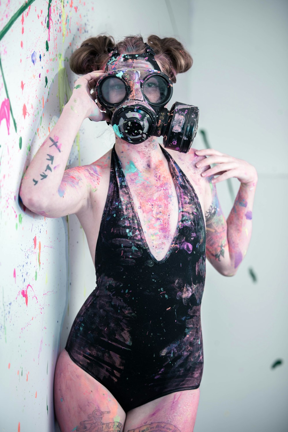 woman wearing air mask while body covered with paints