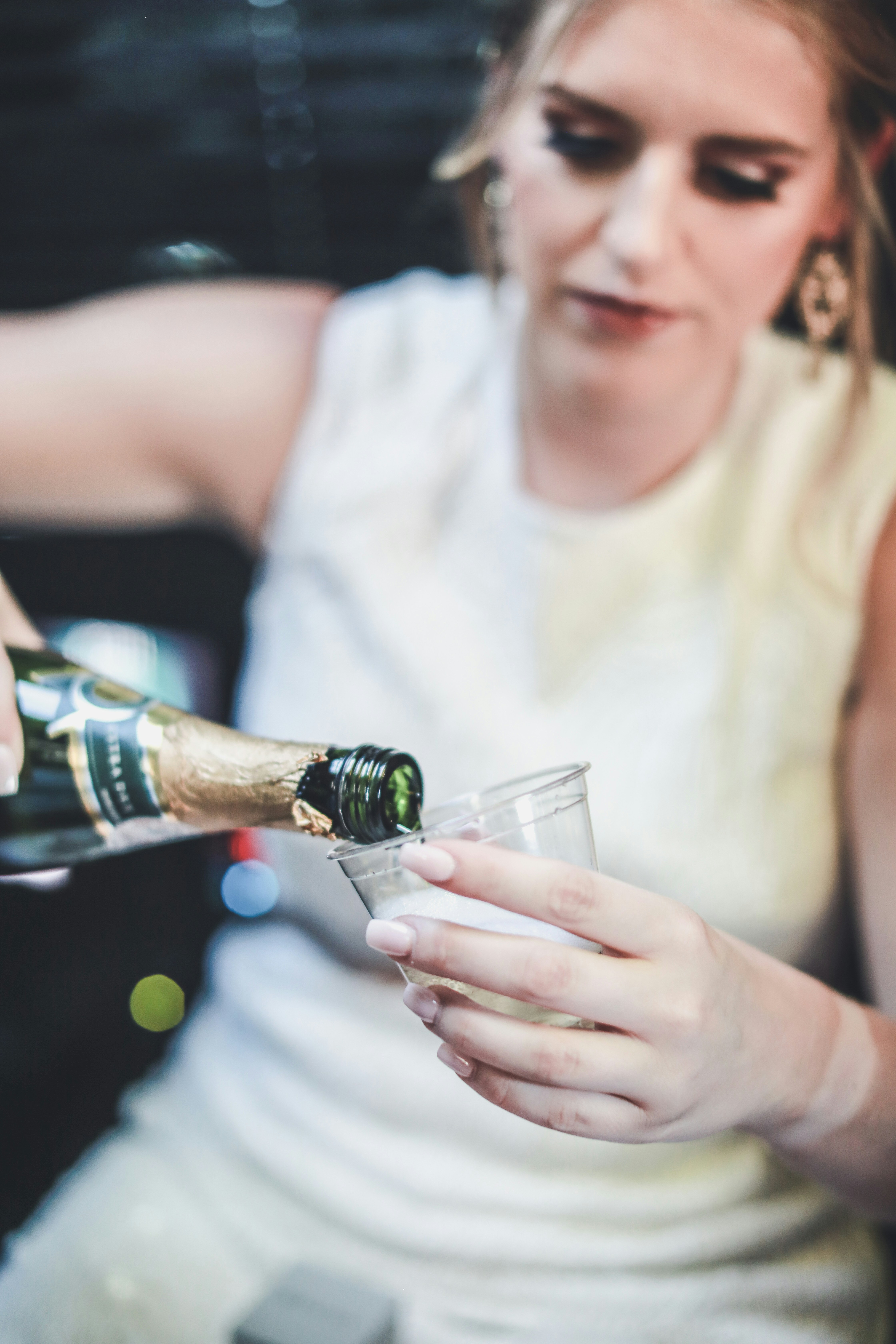 Bride pouring herself champagne in a limo and celebrating at a Las Vegas Wedding.