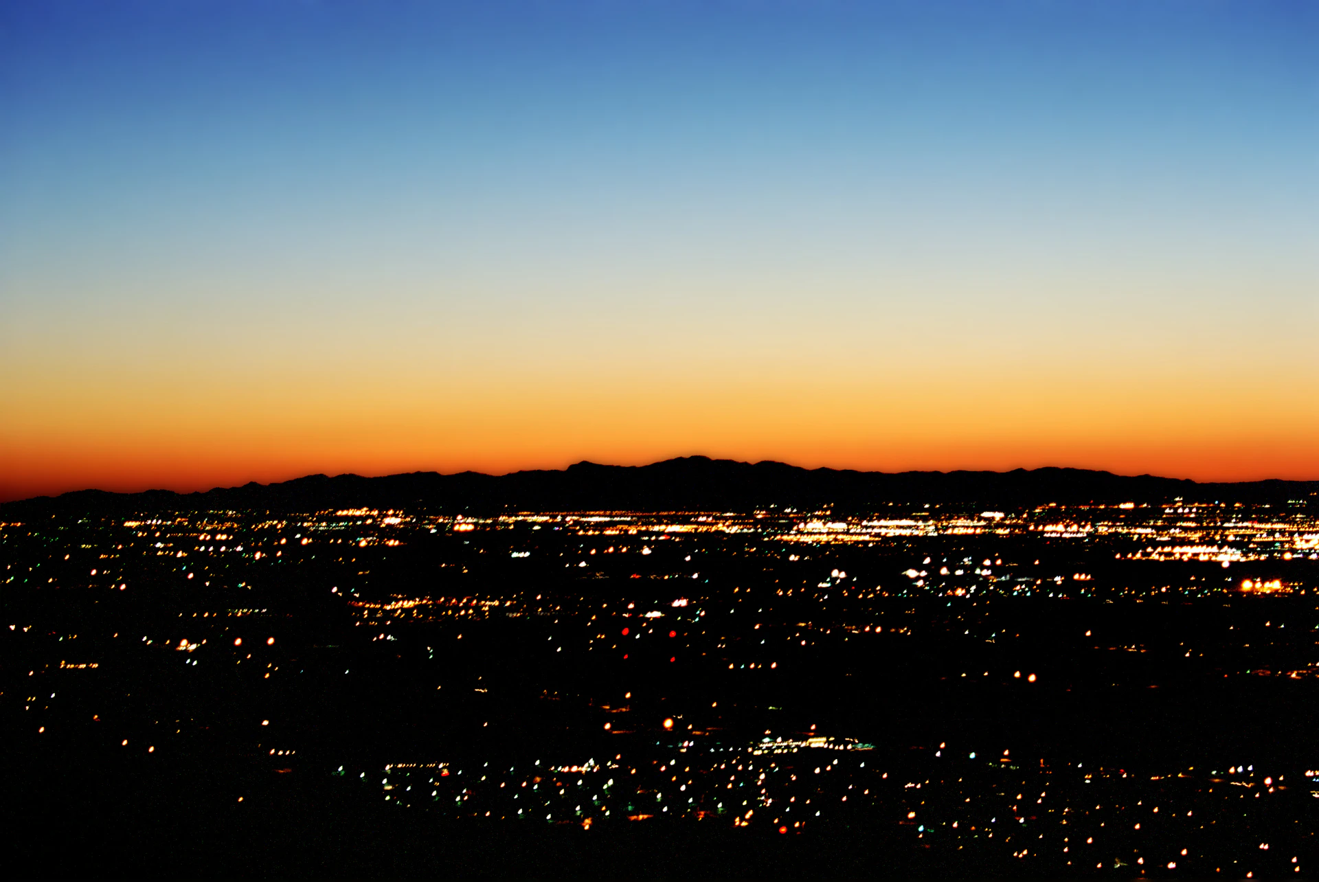 City lights spread across the valley at dusk