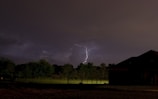Lightning striking over a field in the Munich district at dusk