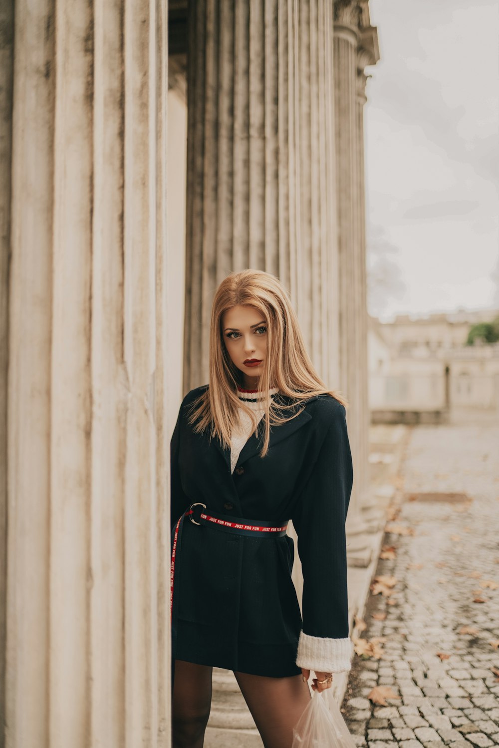 selective focus photography of woman wearing black long-sleeved dress during daytime