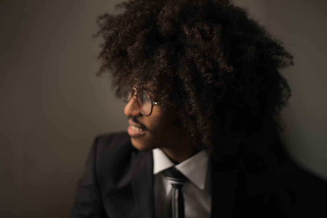 smiling man in black suit