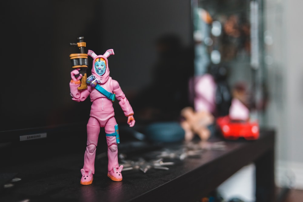 man in rabbit costume holding rifle action figure on black table