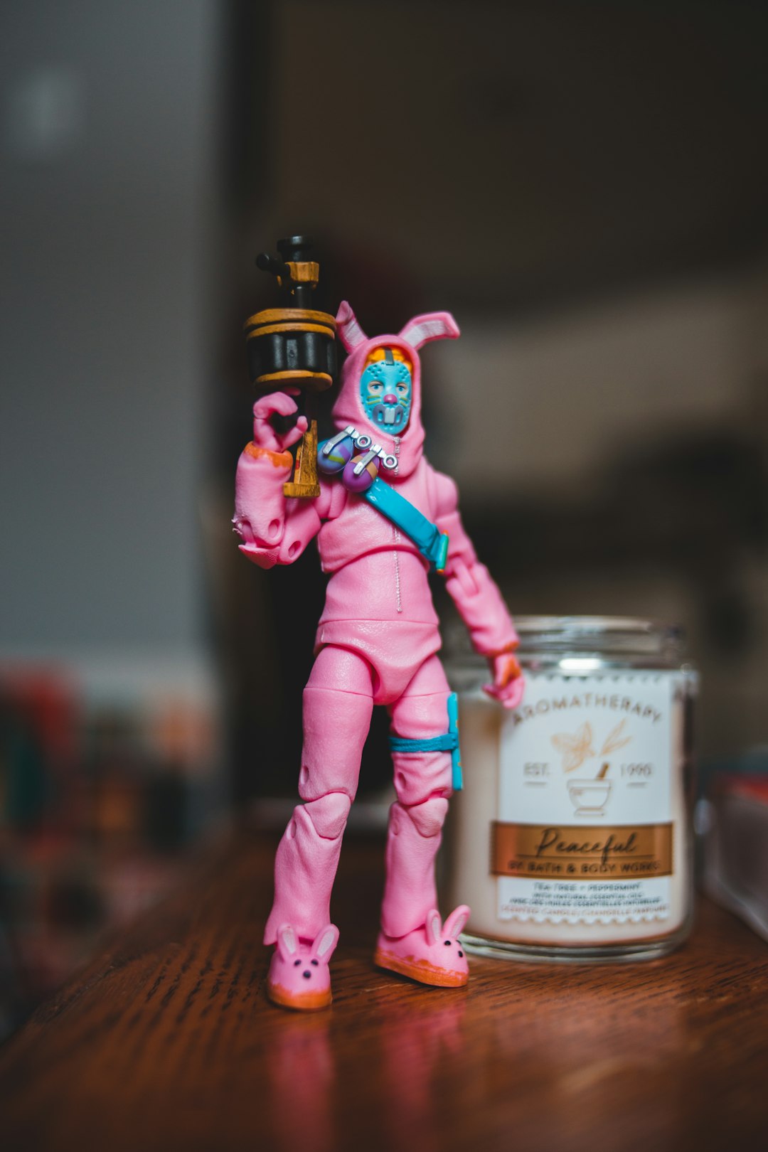 selective focus photography of man in pink costume holding rifle action figure