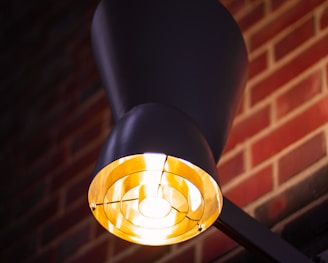 selective focus photography of turned-on black sconce lamp