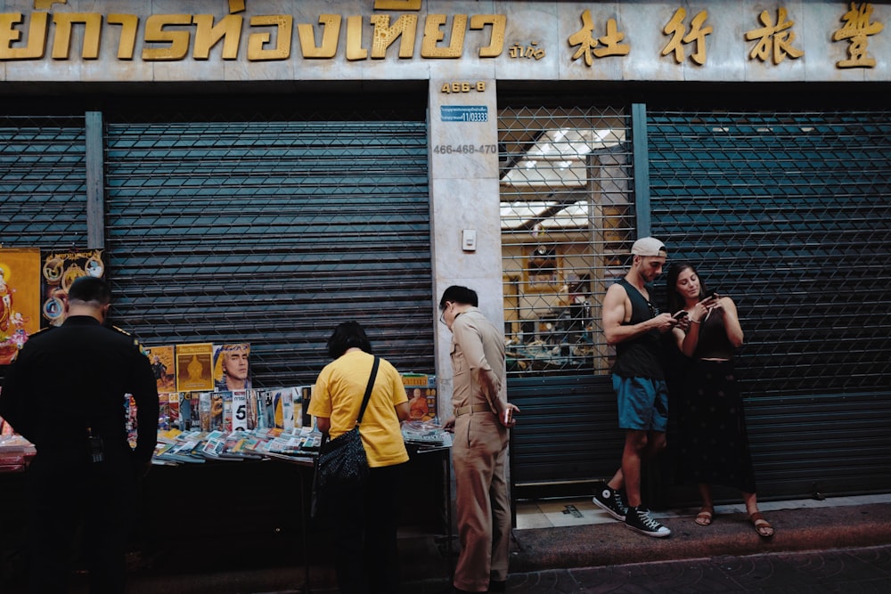 people standing on sidewalk