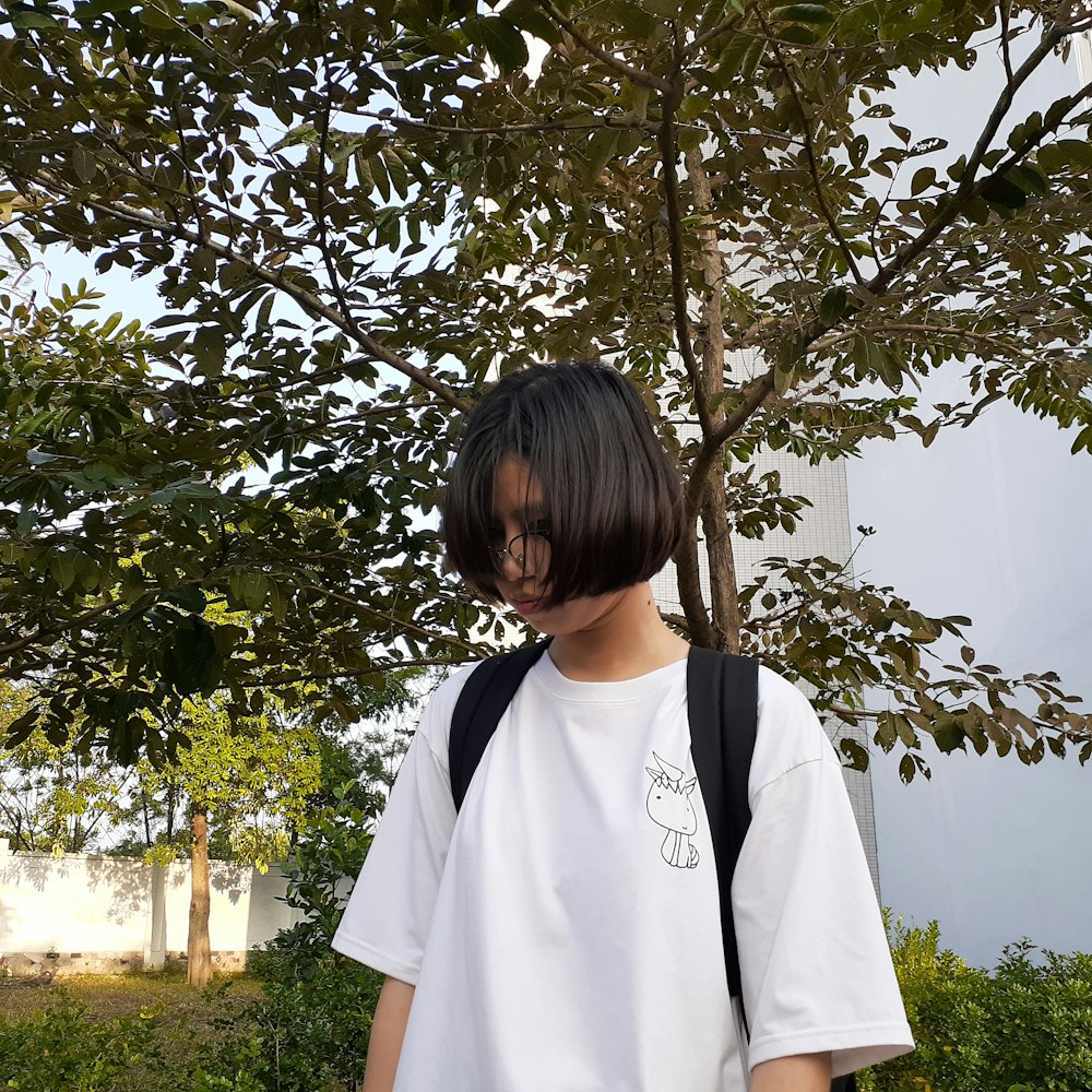 girl standing near tree