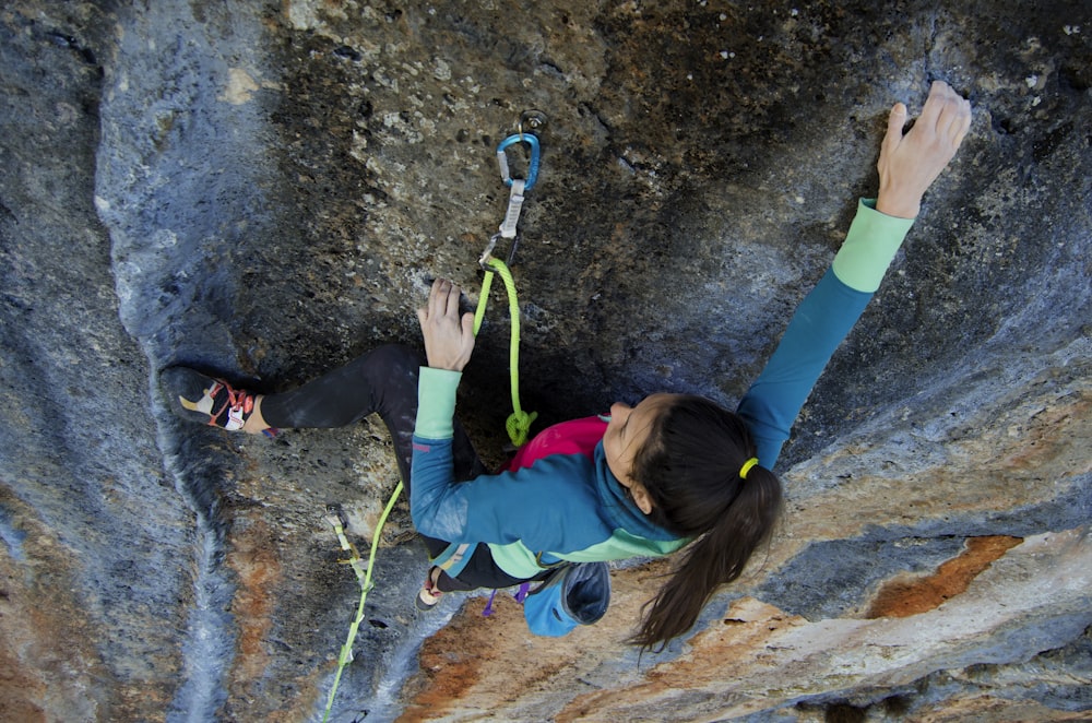 woman climbing on rock