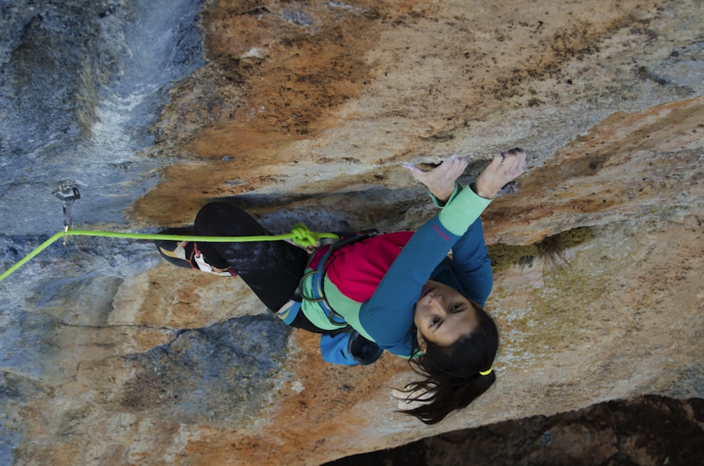 woman climbing on rock