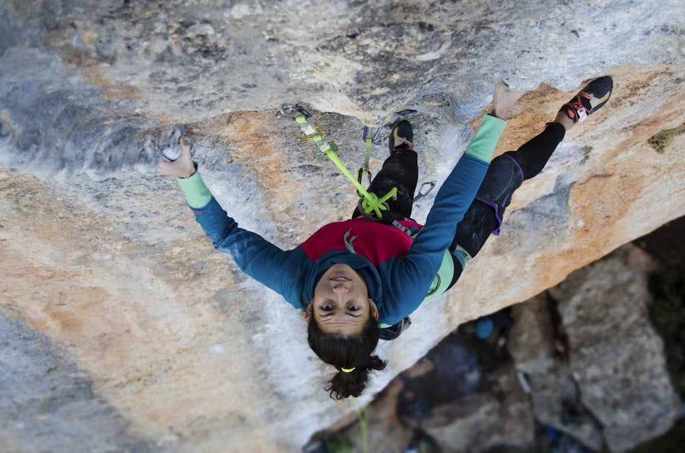 woman climbing on rock