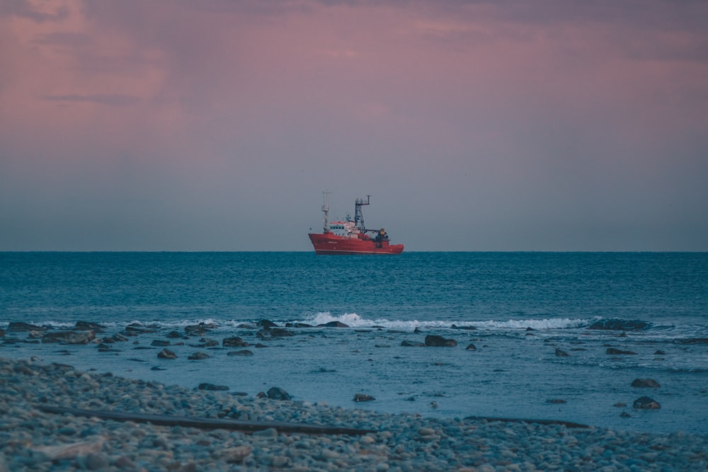 red sailing ship on sea