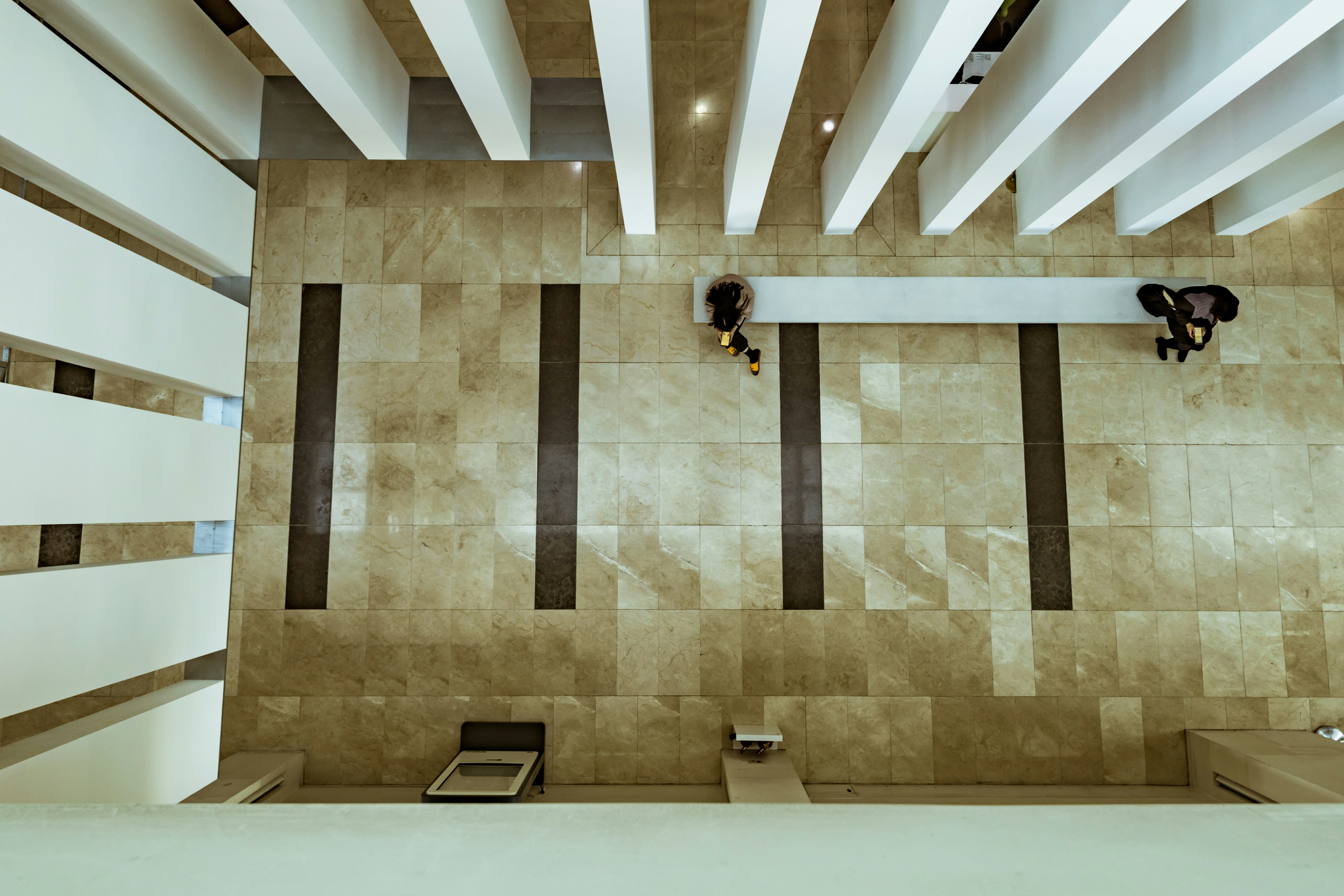 Two Person Standing On Brown And White Ceramic Floor Tiles Photo