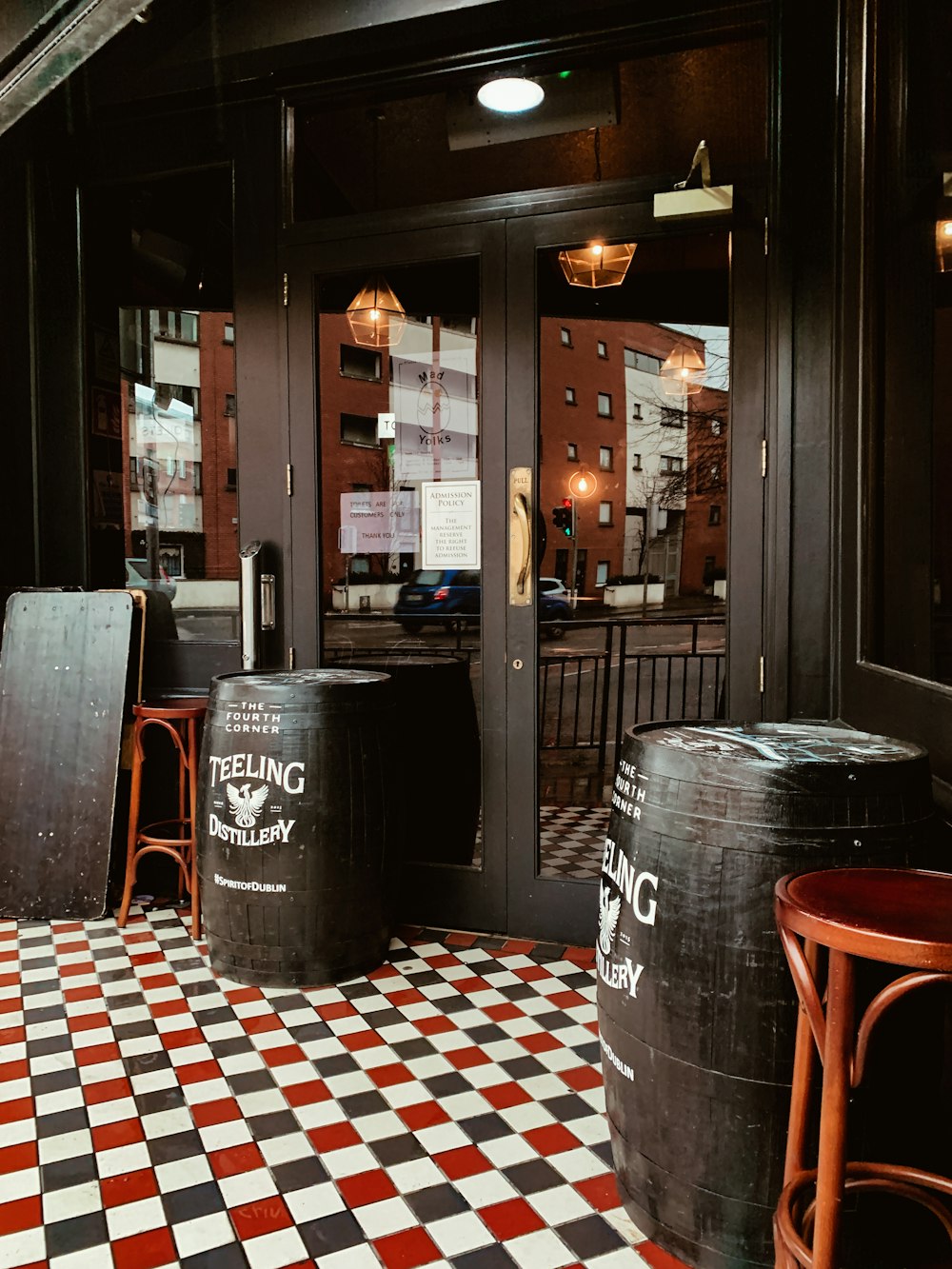 black wooden barrel in front of closed door