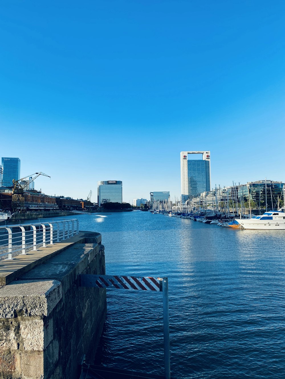 body of water between buildings under blue sky