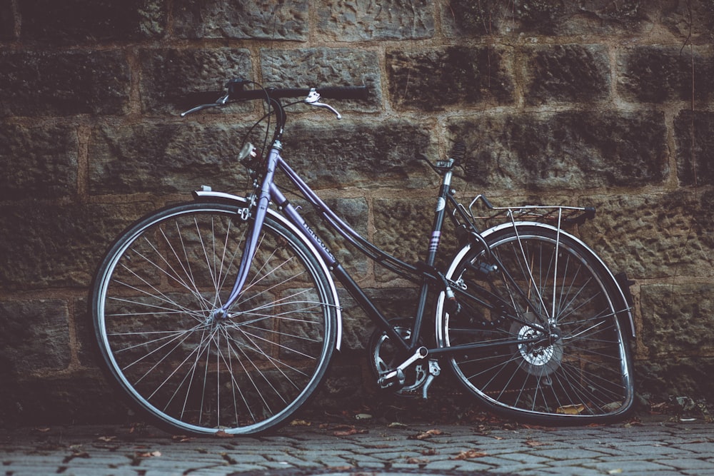 step-through bike with deformed tire placed against wall