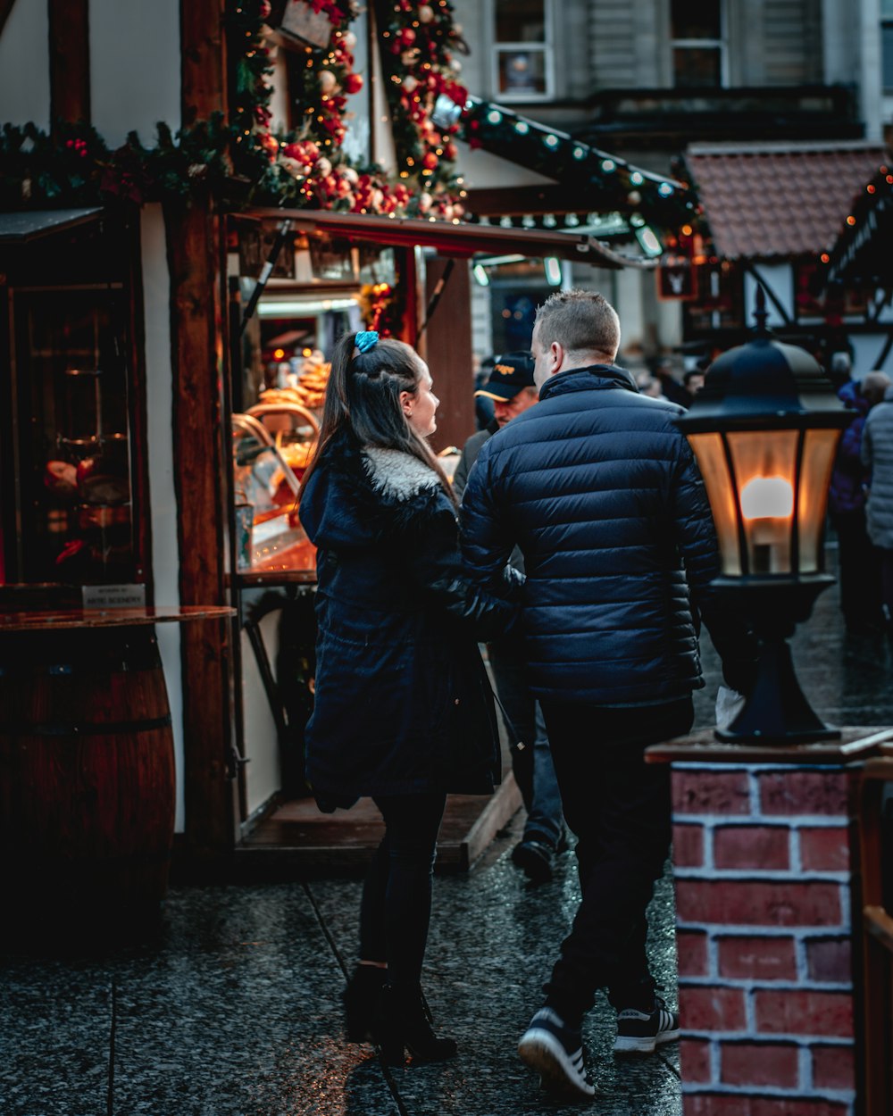 couple walking beside lamp post