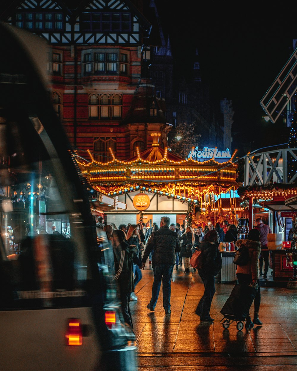 people walking in front of lighted establishment