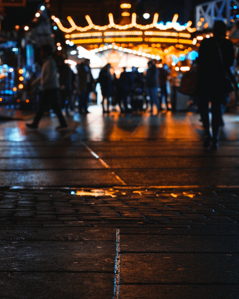 selective focus photography of people walking along a road