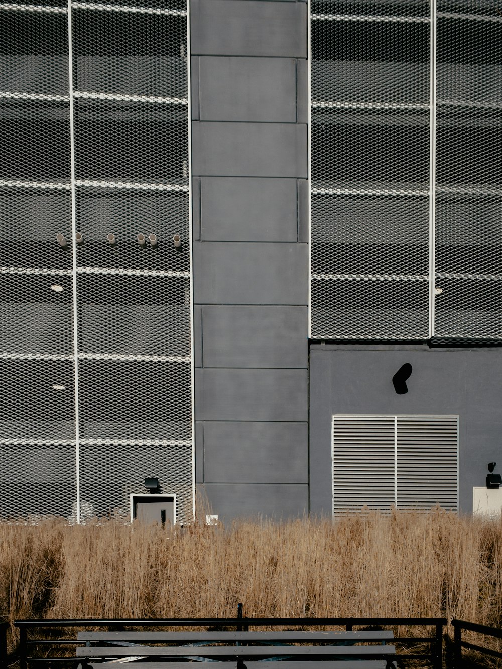 a bench sitting in front of a tall building