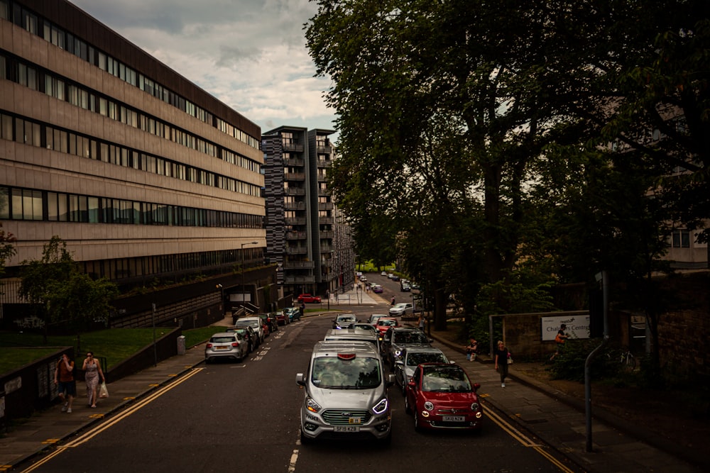 vehicle on road between buildings and trees