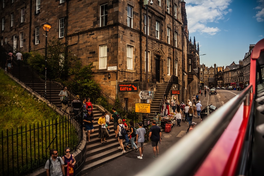 people, buildings, and road during day